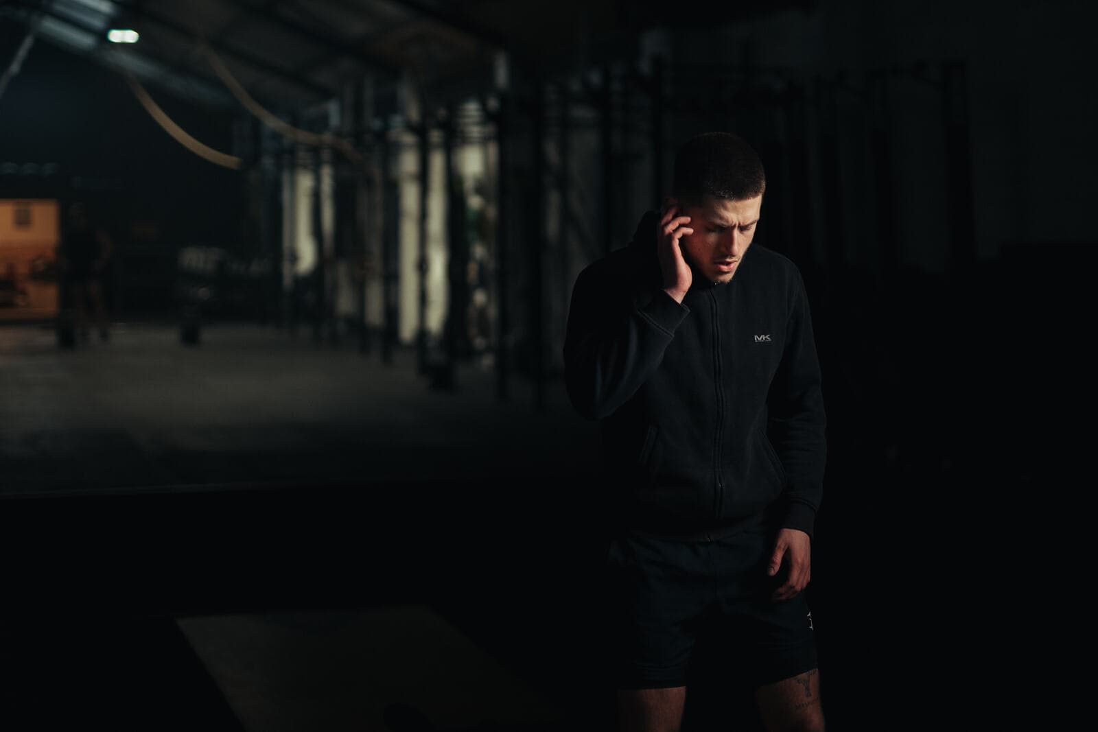 Athlete pressing the touch control on a Tzuka earbud with no phone present