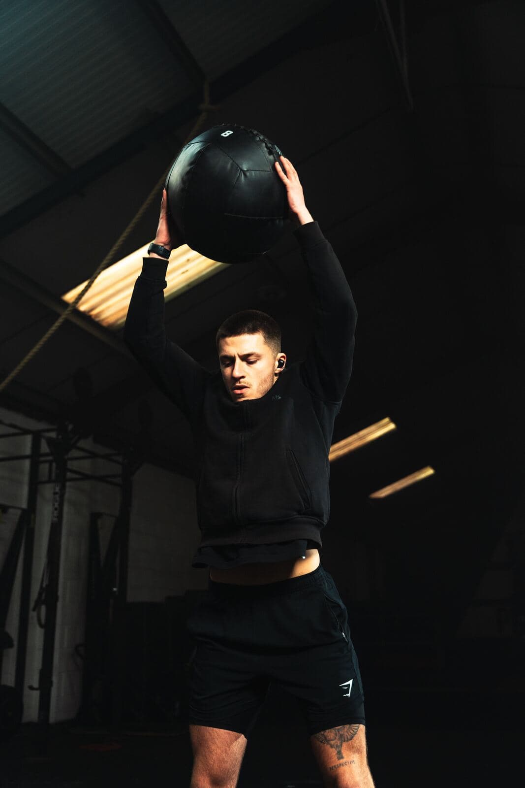 Athlete training with a medicine ball ahead of a first HYROX race