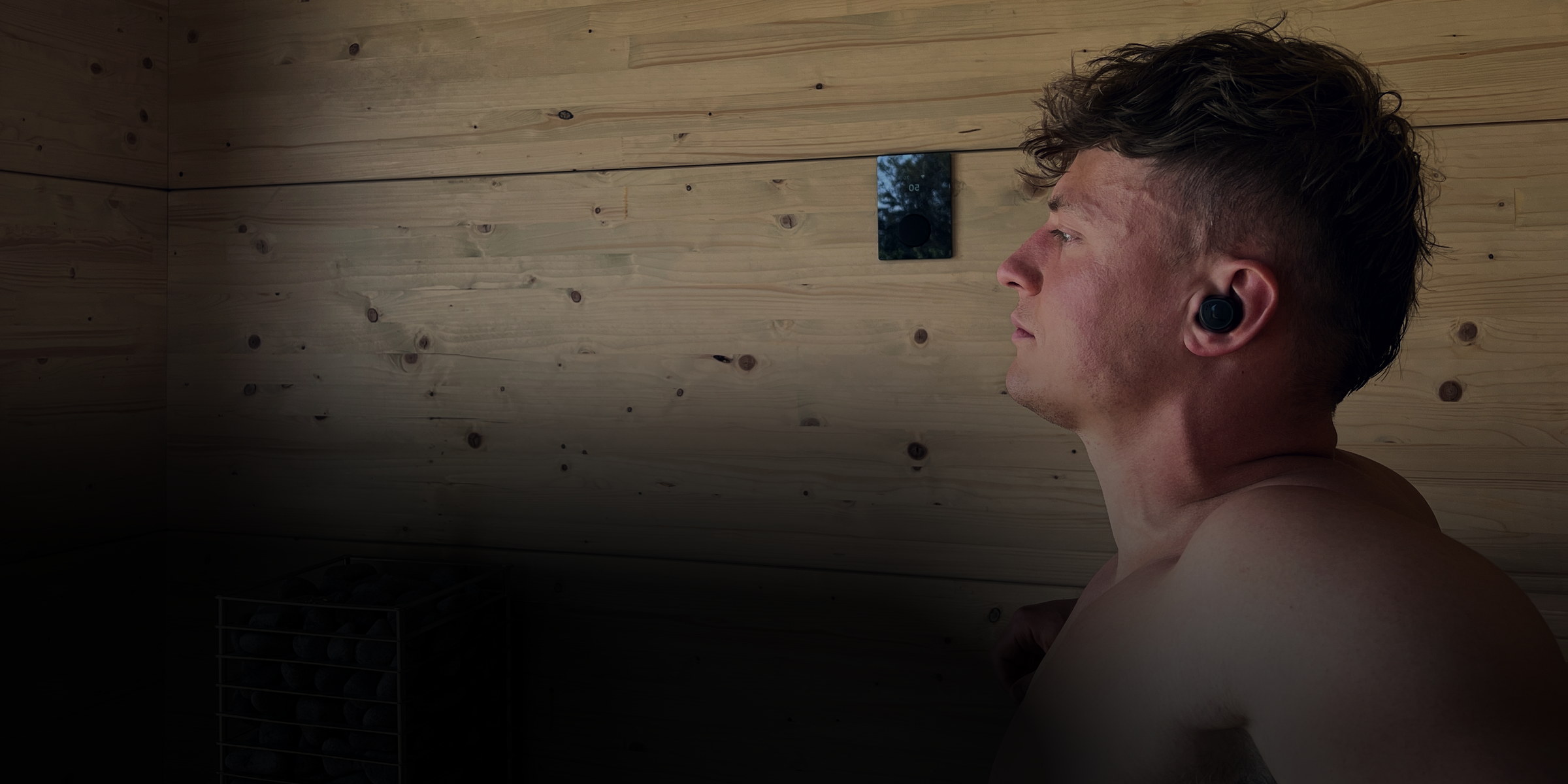 Athlete in a sauna wearing a TZ7 Ultra earbud